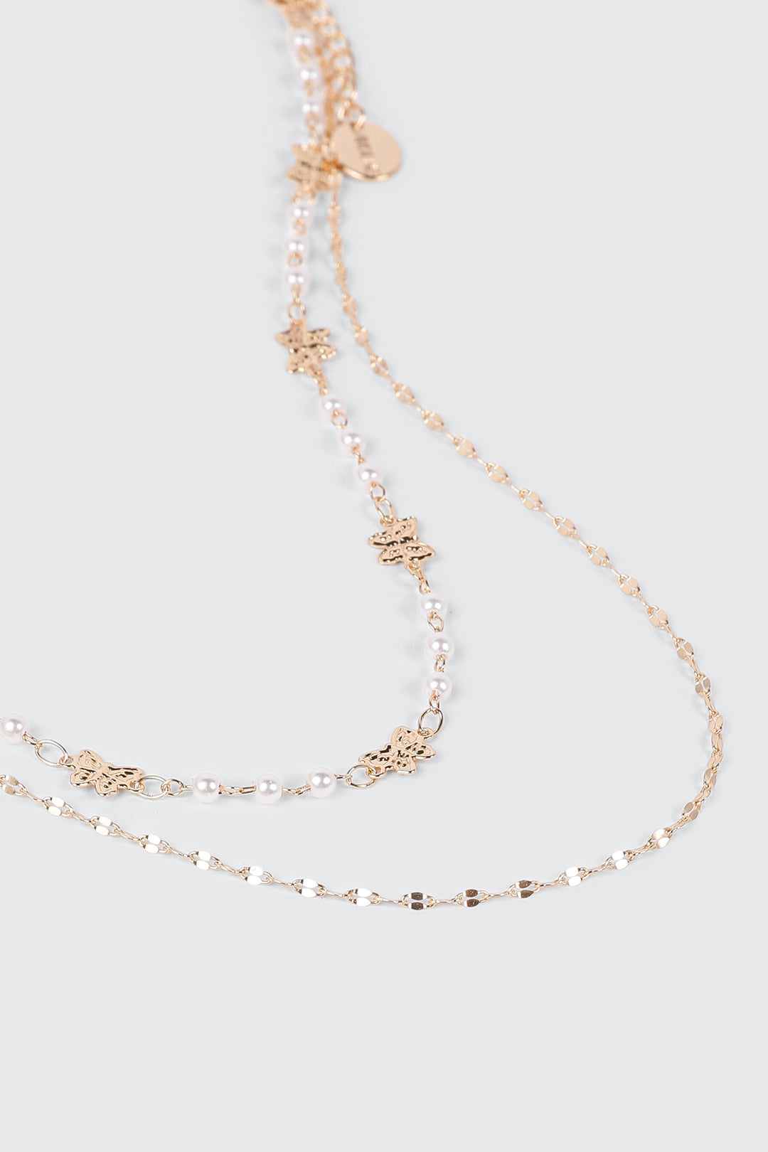 Collier à deux rang perles et boucles