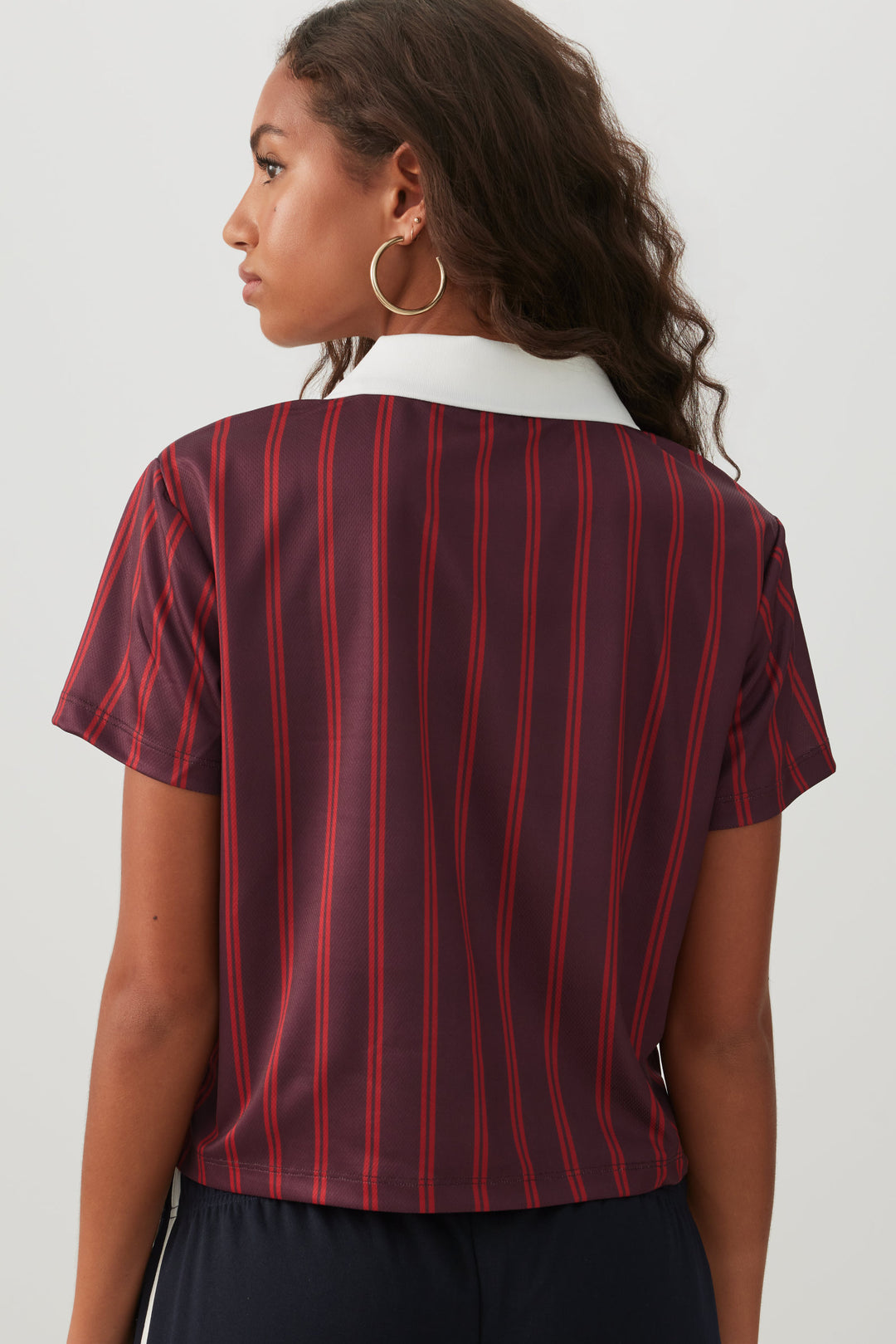 Haut polo rayé en maille filet